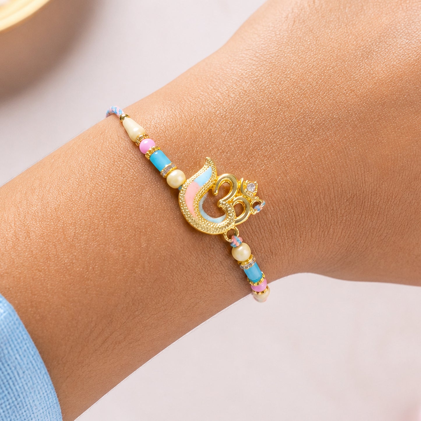Peacock and Om Enamel Pendant Rakhi with Pastel Beads