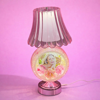 Illuminated round photo table lamp showing soft warm glow