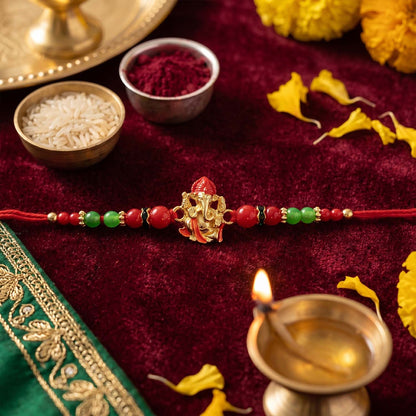 Side view of golden Ganesha designer Rakhi