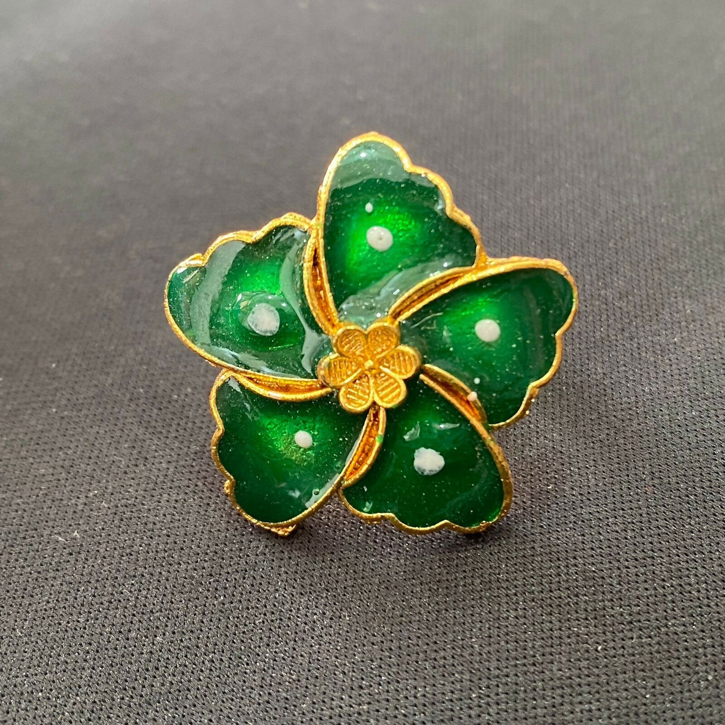 Model wearing the vibrant green floral statement ring on her finger.