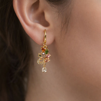 Close-up of multicolor gemstone leaf motif drop earrings with crystal accents