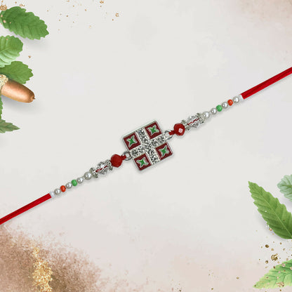 Top view of classic square Rakhi showcasing intricate Meenakari work and vibrant colors