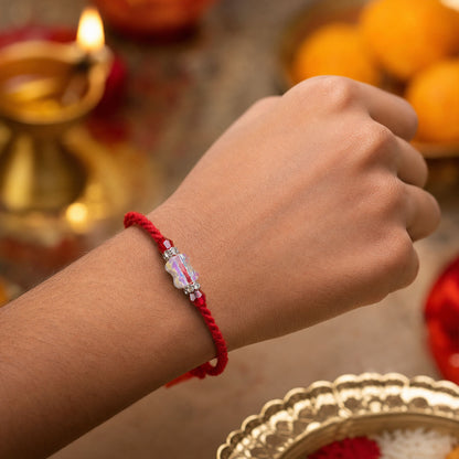 Red Thread Rakhi with an Iridescent Bow-Tie Shaped Crystal Bead