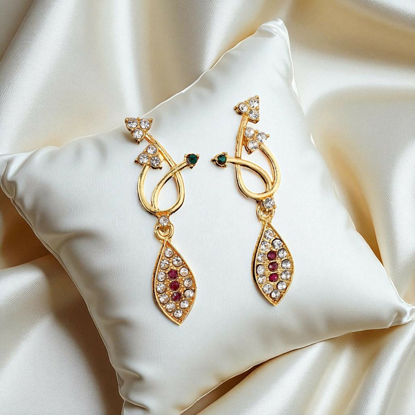 Matching gold-toned drop earrings with black stones and American Diamonds