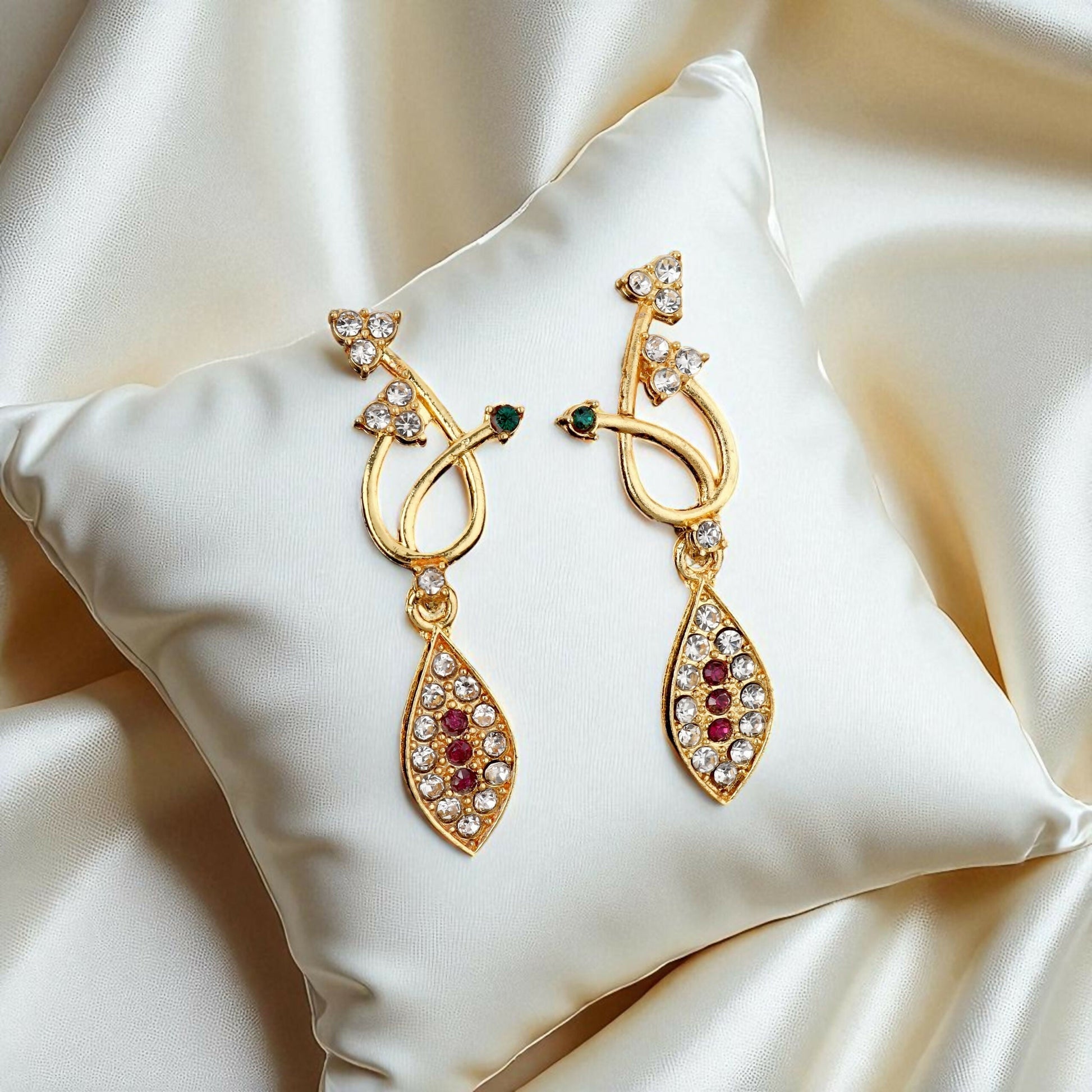 Matching gold-toned drop earrings with black stones and American Diamonds