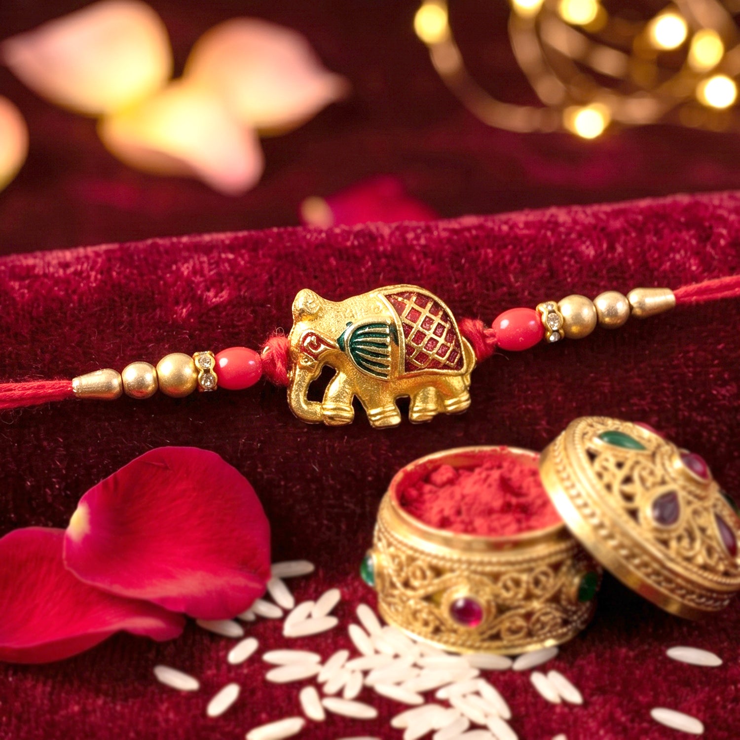 Gold Elephant Rakhi with Red Beads and Pearl Side Detailing