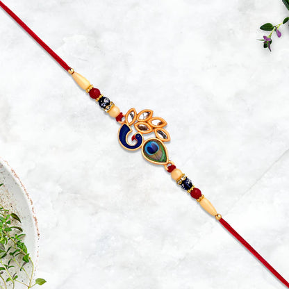 Artisan handcrafted Mor Pankh Rakhi showing its unique traditional thread.