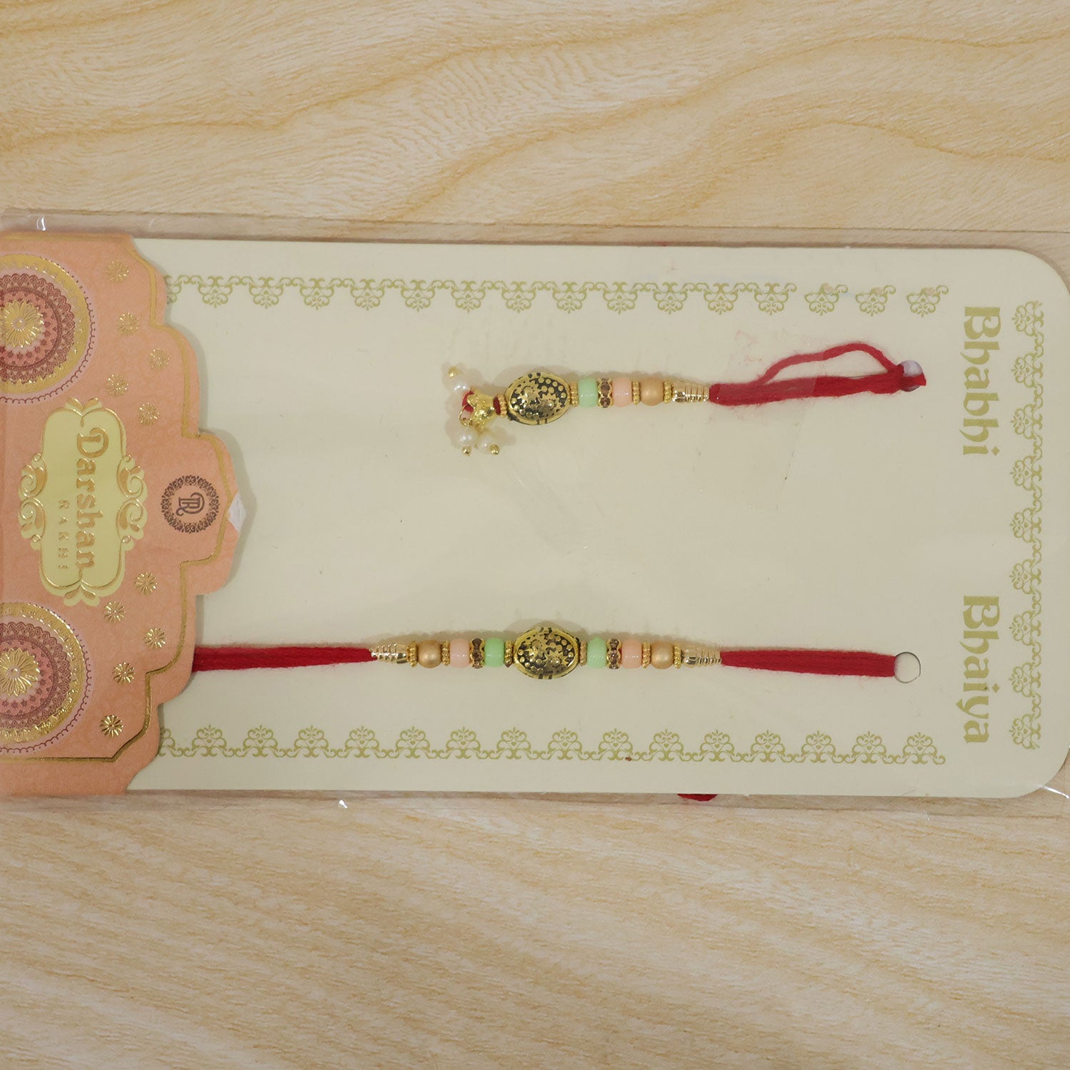 Divine Circular Medallion Bhai Bhabhi Rakhi with Oval Charm and Bead Accents for Gift
