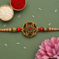 Antique Gold Floral Medallion Rakhi for Brother with Red Crystal Peach Pearl Beads