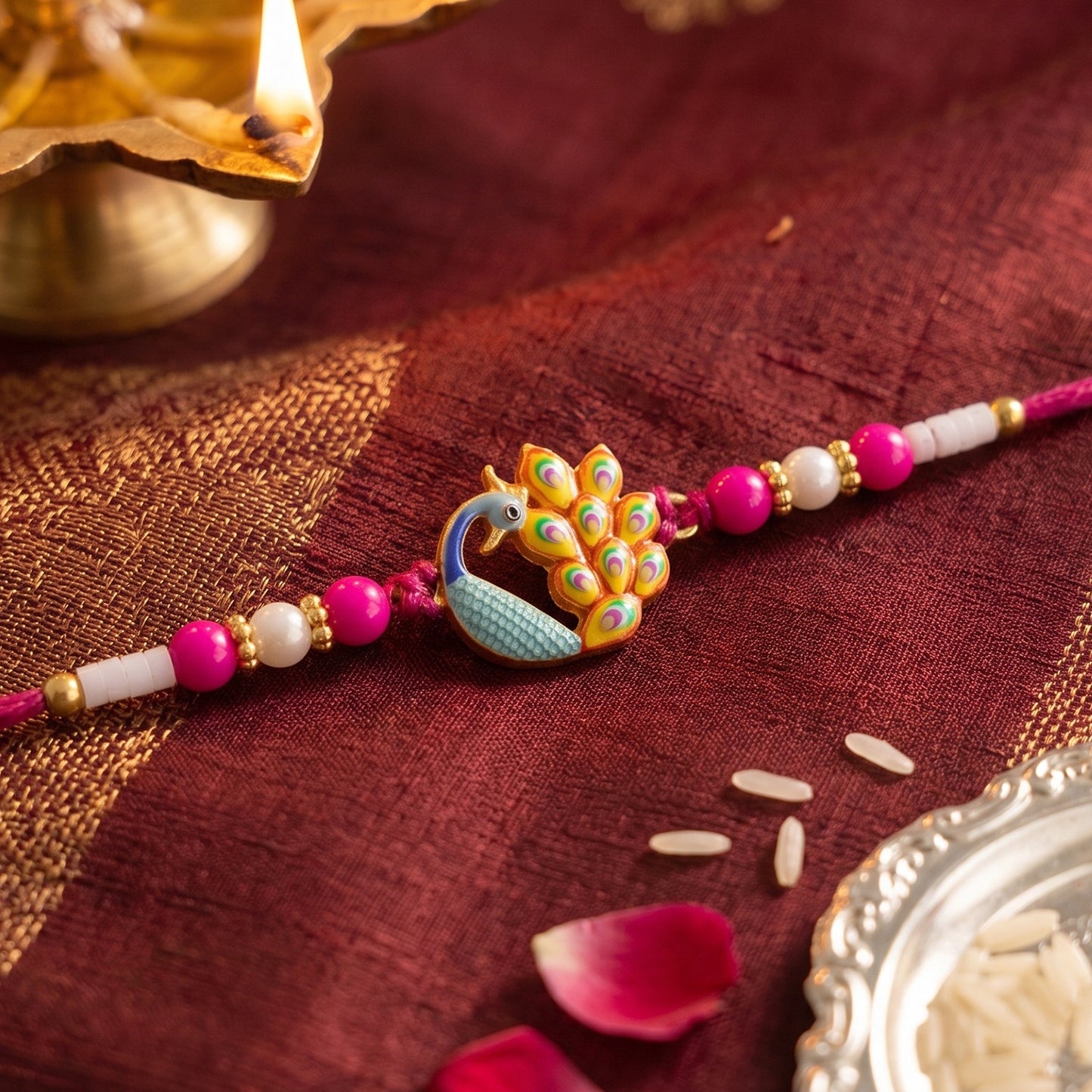 Detailed close-up of Peacock Meenakari centerpiece on Rakhi