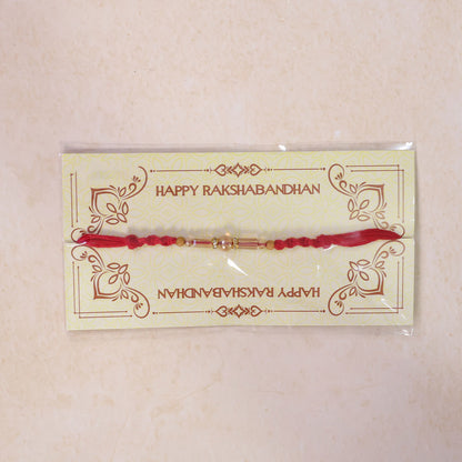 Red Braided Rakhi with Wooden Beads and a Pink Crystal Cylinder Bead