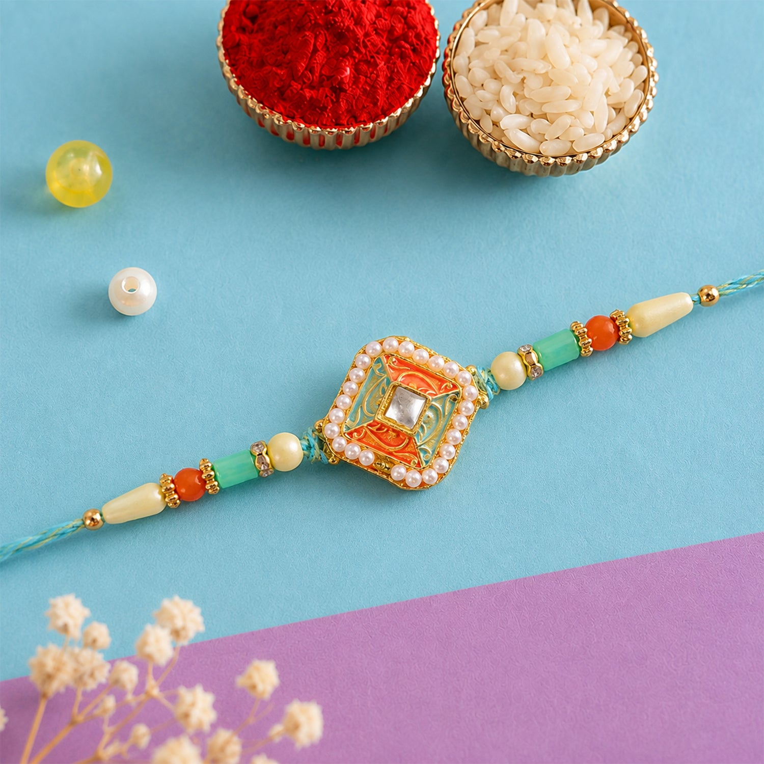 Pearl Bordered Meenakari Pendant Rakhi with Orange and Teal Enamel