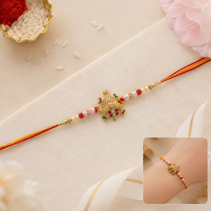 Gold Turtle Rakhi with Pink Pearls and Red Thread