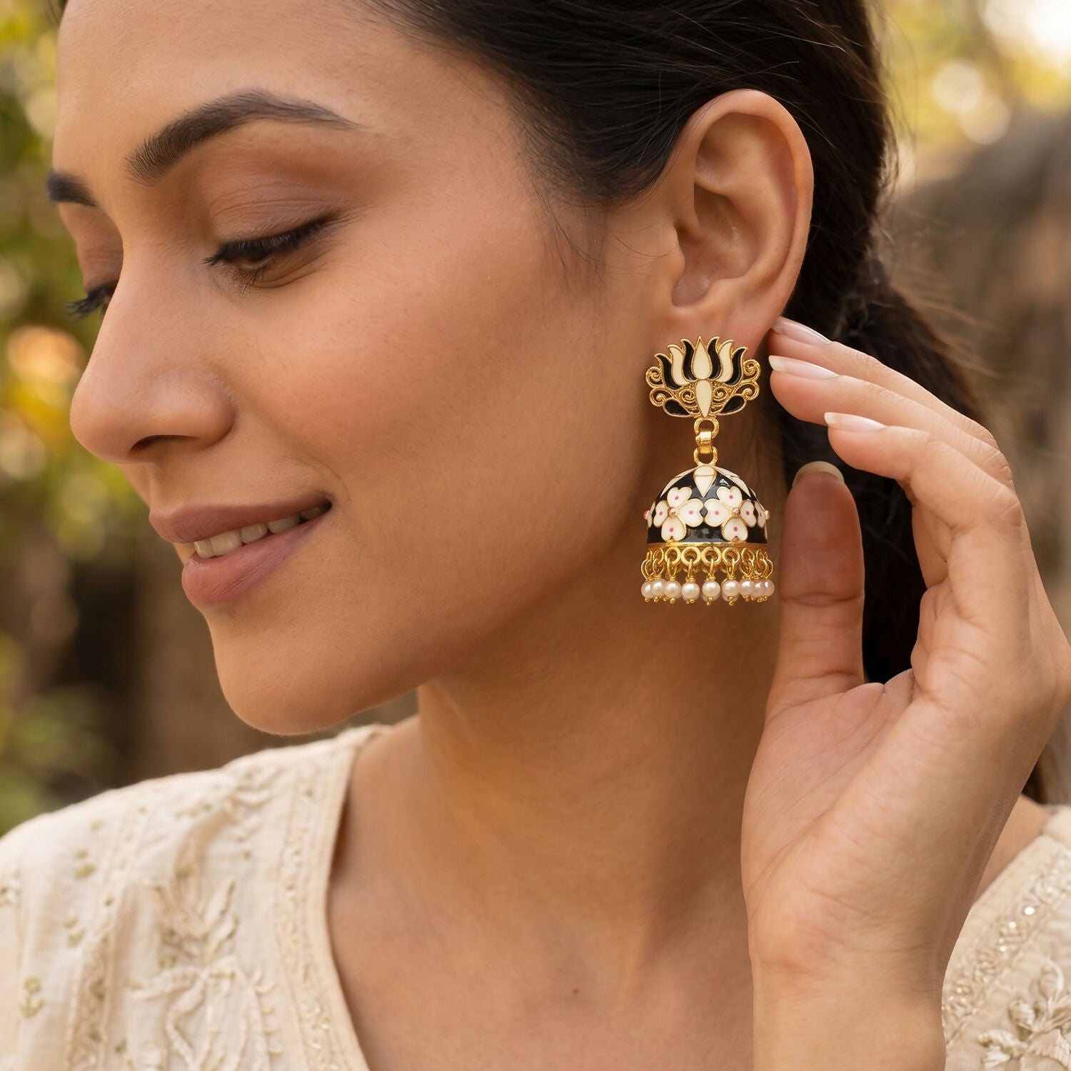 Close-up of floral dome design on grey lotus jhumka earrings