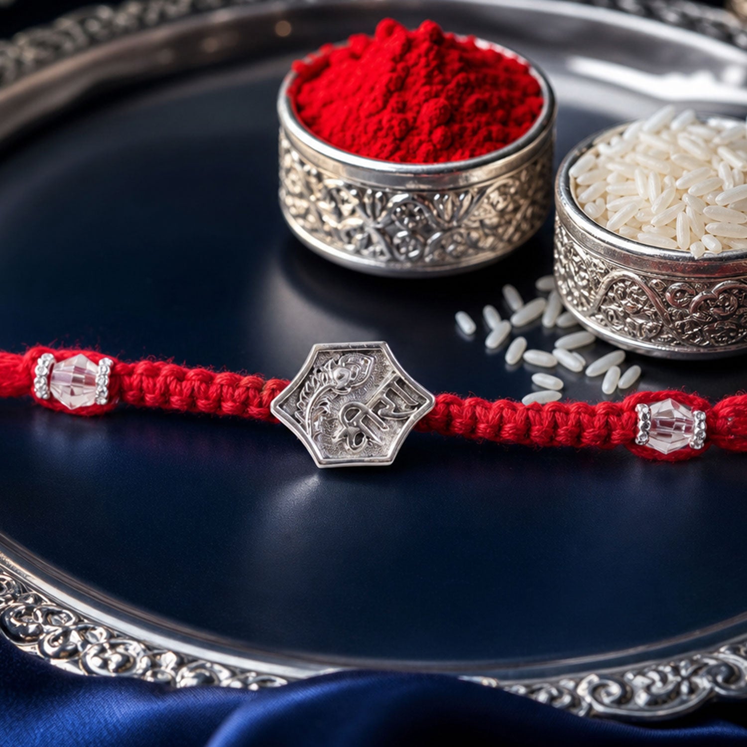 Red Thread Rakhi with Engraved Silver Shield-Shaped Charm Pendant