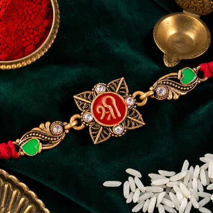 Antique Gold-Toned Shree Rakhi with Crystal Accents, Green Enamel & Designer Red Thread