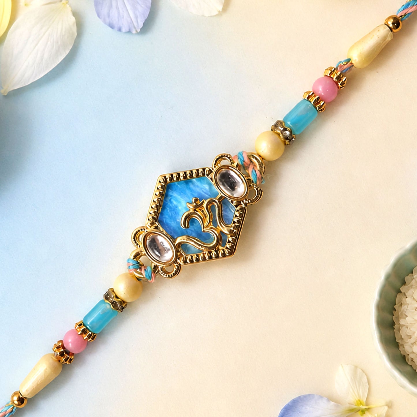 Om Hexagon Pendant Rakhi with Blue Enamel and Kundan Stones