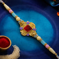 Ornate Rakhi showcasing Square Crystal Charm, gift finish and chain look for Gift Use
