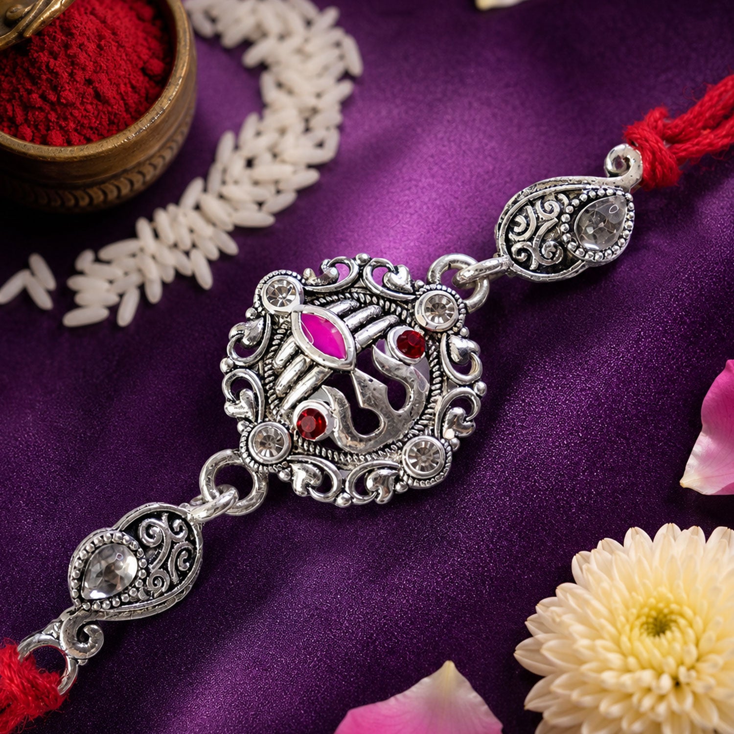 Premium Rakhi showcasing Silver Om Leaf Charm, gold trims and chain look for Gift