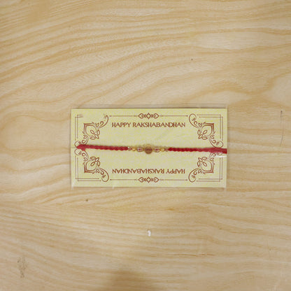 Red Thread Rakhi with Golden and Sparkling Crystal Bead Accents