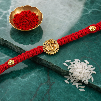 Red Thread Rakhi with an Antique Gold Om Pendant and Beaded Accents