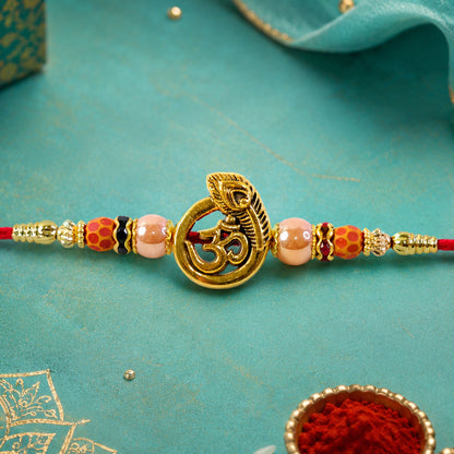 Om Peacock Golden Devotional Rakhi with Sacred Symbol, Pearl Beads and Red Thread