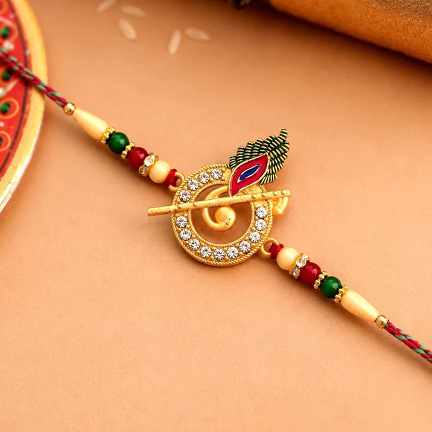 Krishna Bansuri Studded Crystal Rakhi with Cute Doll Keychain Combo (2 Pc)