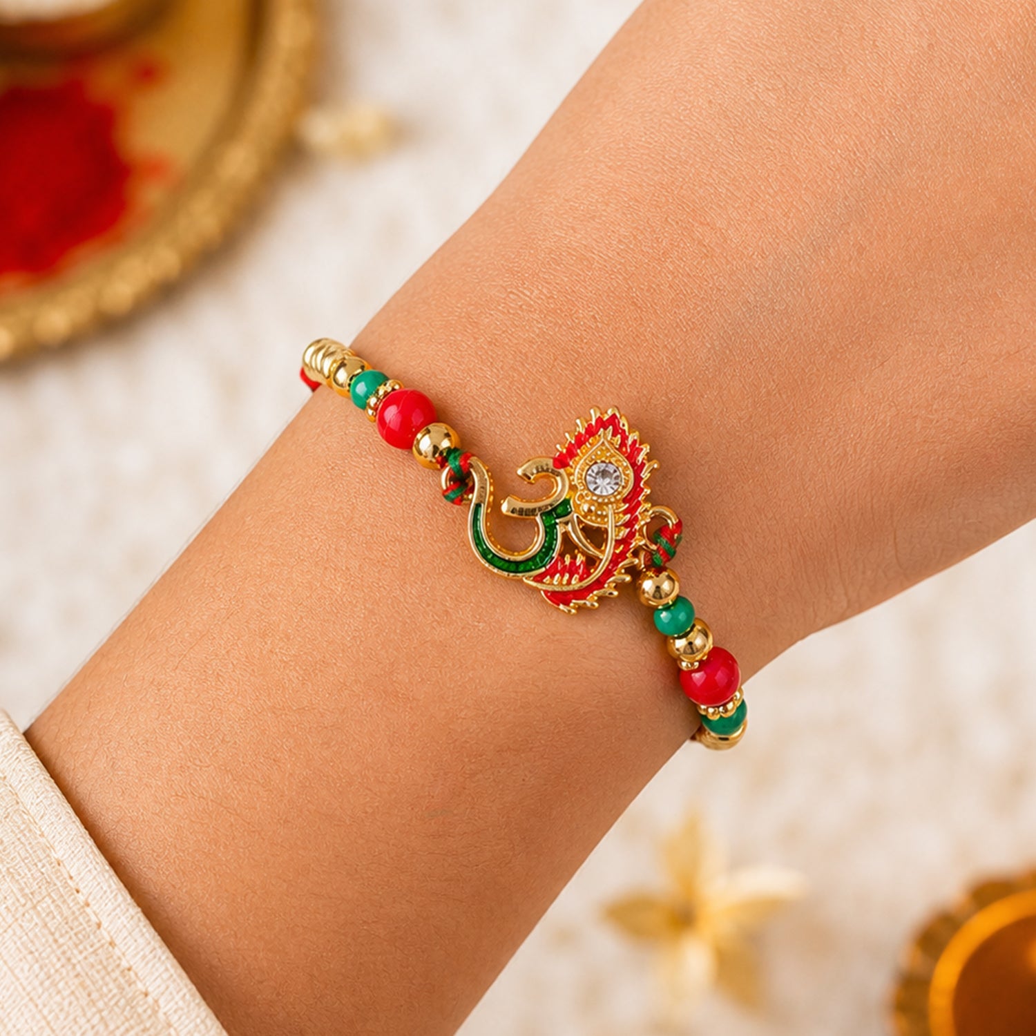 Om and Peacock Feather Enamel Pendant Rakhi with Multicolor Beads