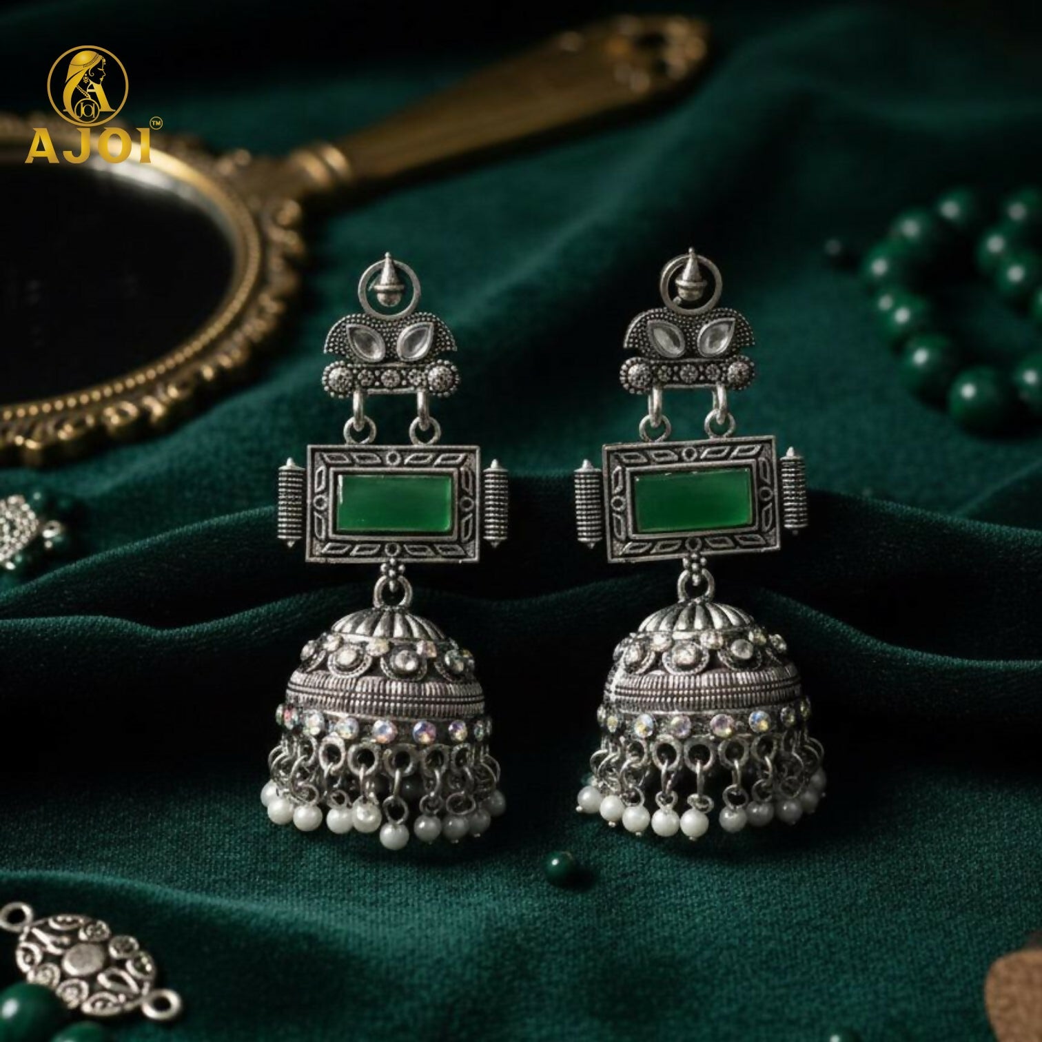 Imperial Heritage Oxidized Silver Jhumka Earrings with Deep Green Stone, Hand-Engraved Motifs, Crystal Accents & Pearl Drop Detailing.