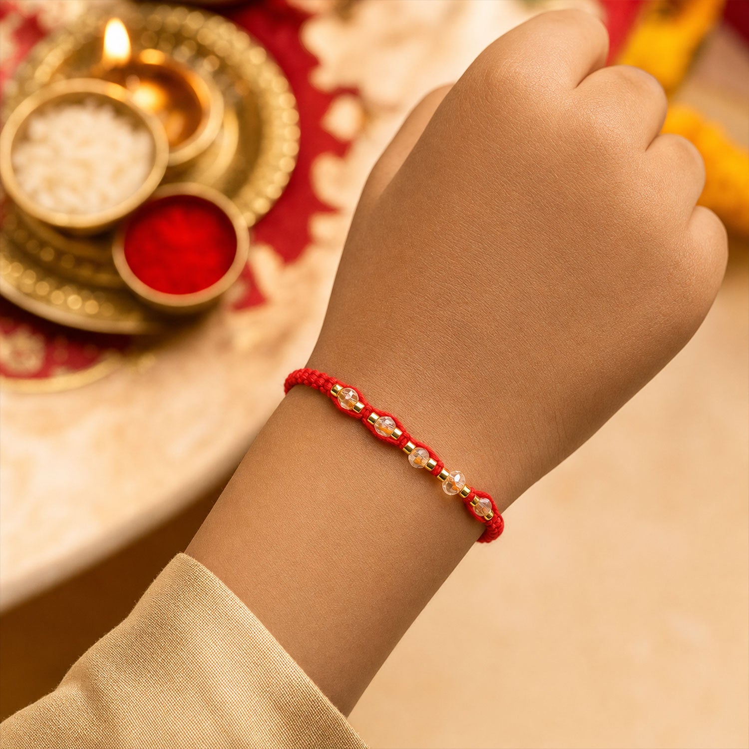 Red Braided Rakhi with Crystal Bead Pendant and Golden Accents