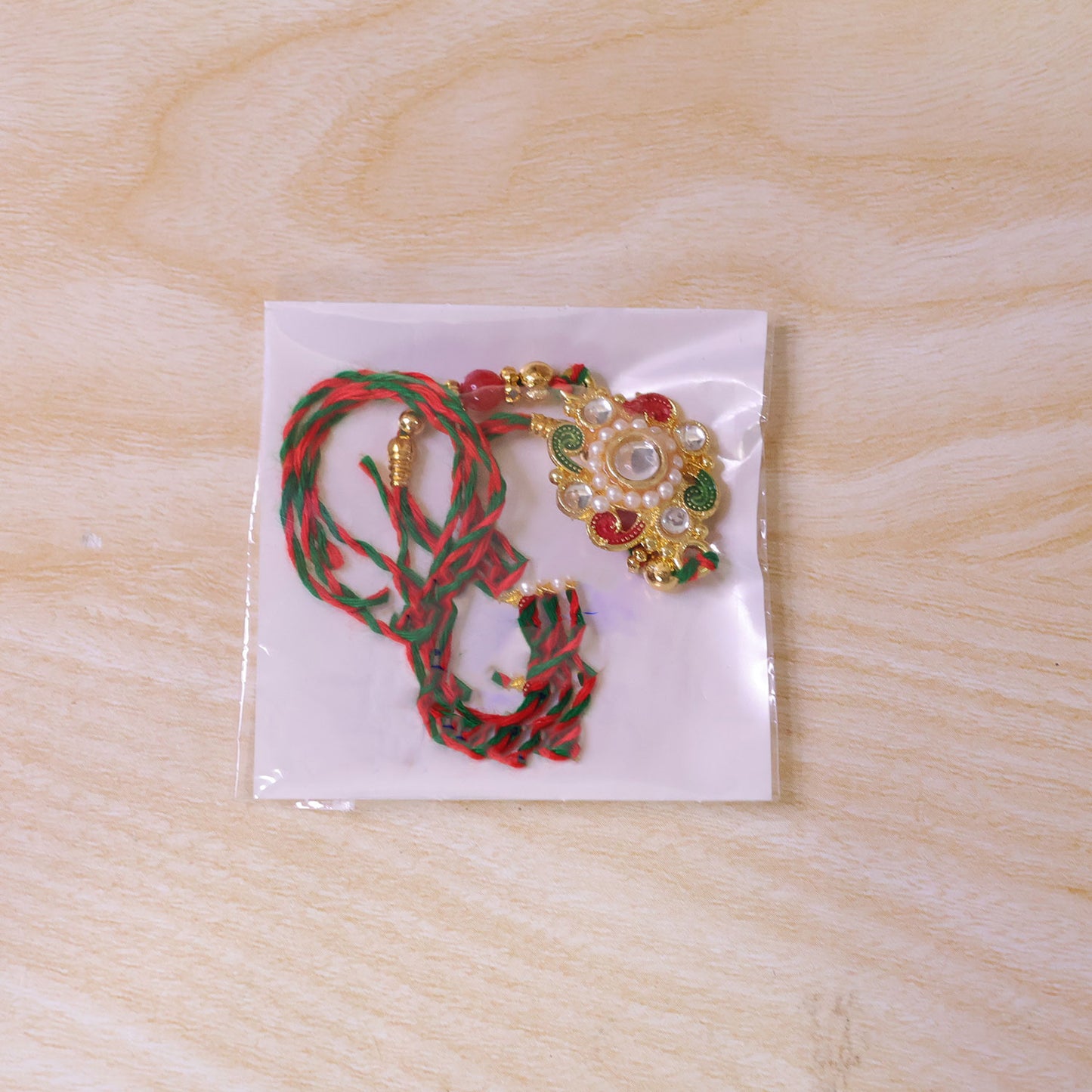 Elegant Rakhi with Floral Medallion and bead line in chain look for Gift Styling