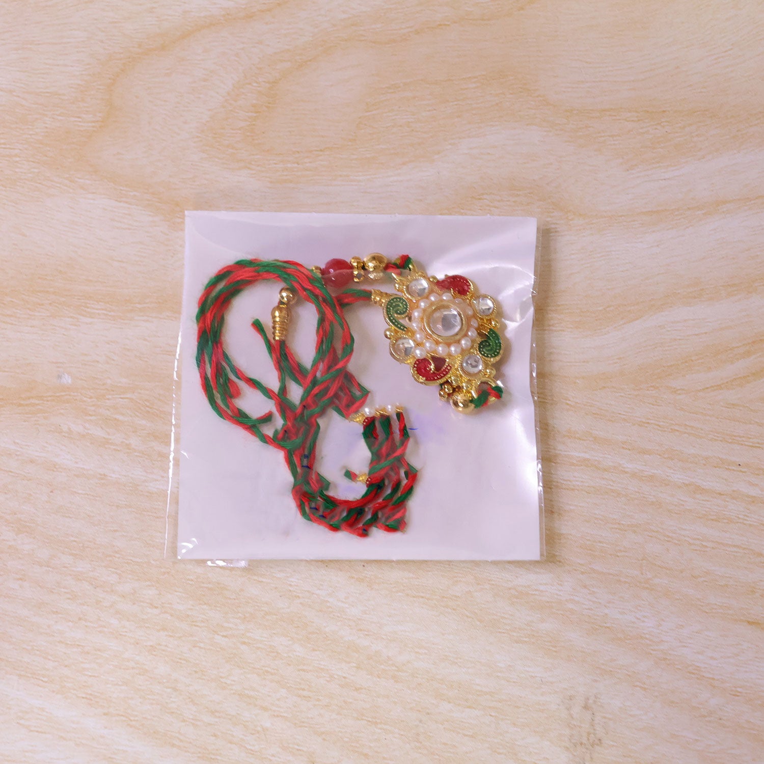 Elegant Rakhi with Floral Medallion and bead line in chain look for Gift Styling