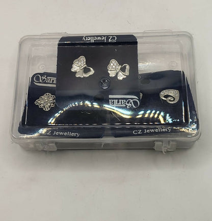 Packaging for the silver-plated stud earrings set, featuring flower, heart, and bow designs.