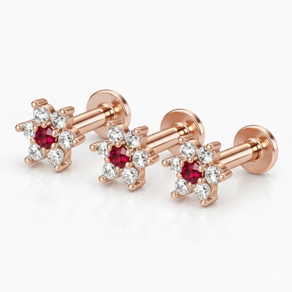 Set of three rose gold floral flat back stud earrings showcasing ruby and diamond design