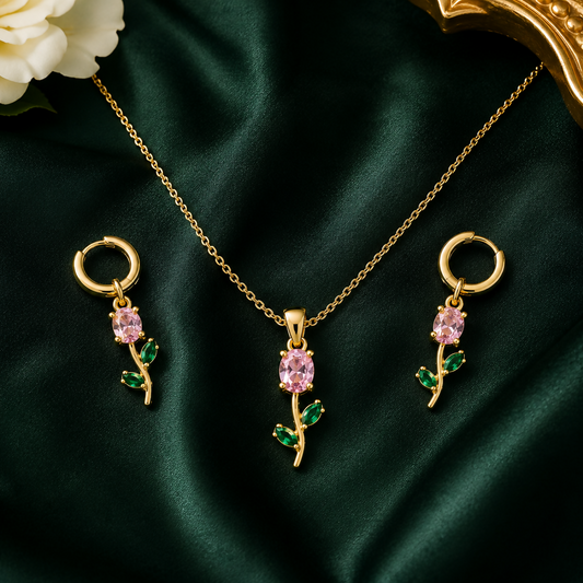 Pink crystal floral pendant necklace set with matching earrings displayed elegantly.