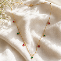 Gold Necklace with Alternating Red and Green Square Gemstone Charms