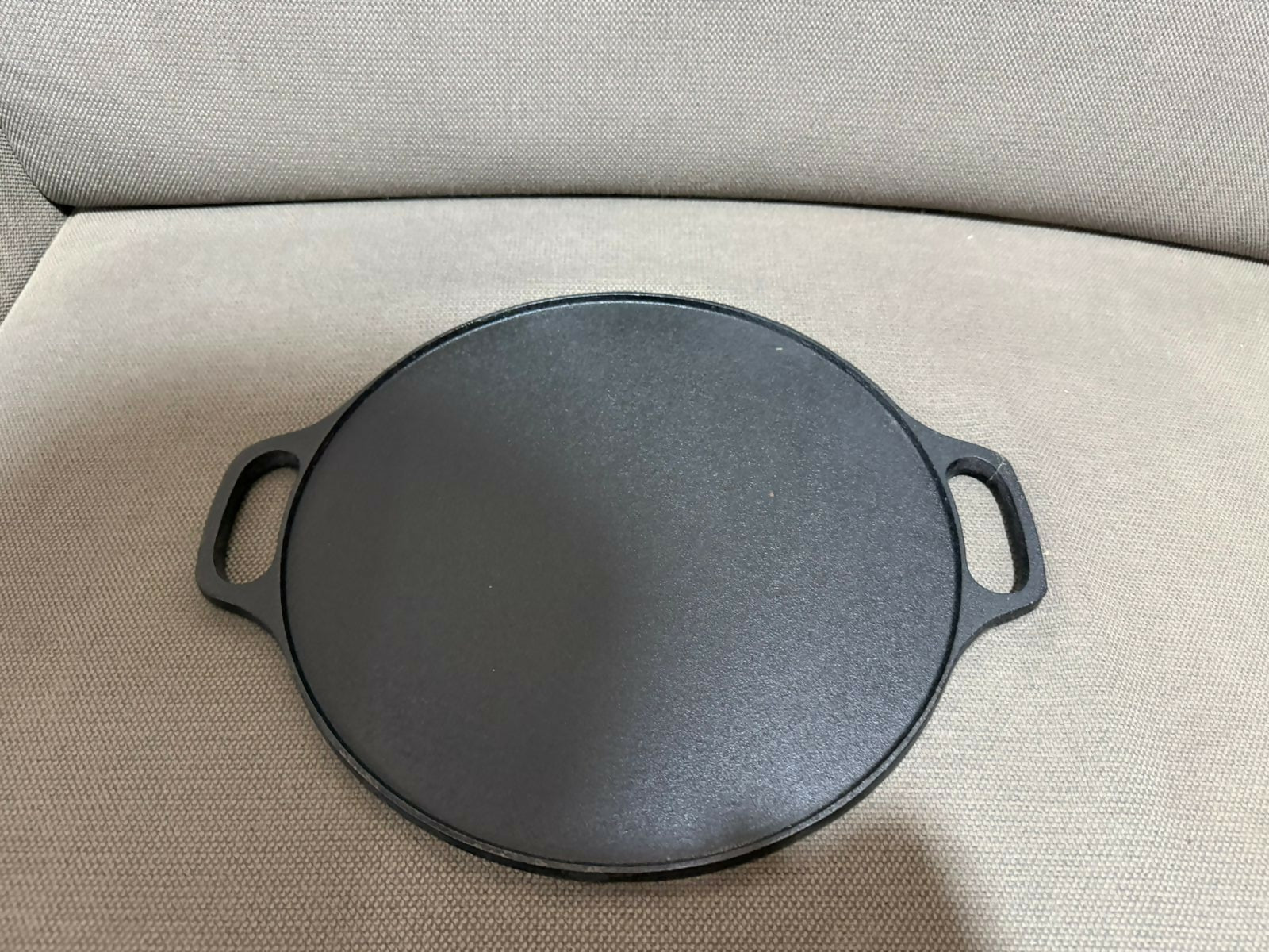 Vikas cast iron flat tawa on stovetop
