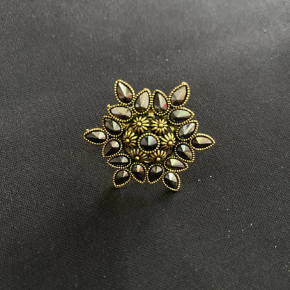 Women's antique gold crystal ring, styled on a hand for a traditional look.