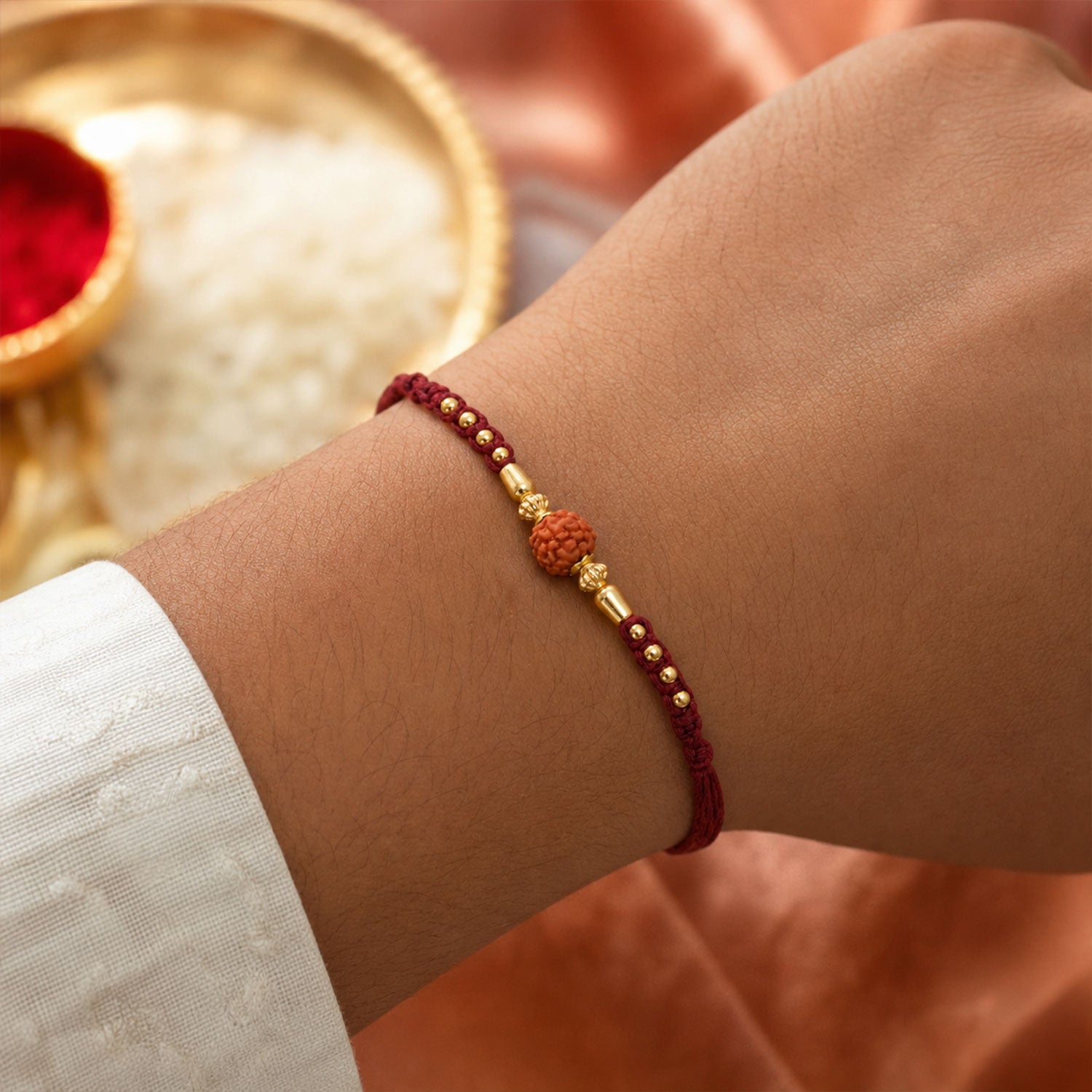 Red Braided Rakhi with a Rudraksha Bead and Wooden Bead Accents