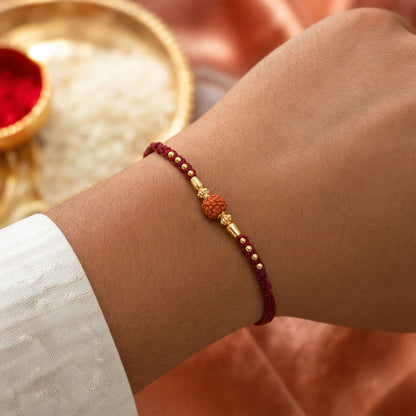 Red Braided Rakhi with a Rudraksha Bead and Wooden Bead Accents