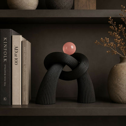 Contemporary resin sculpture with intertwined knot design, ideal for modern interiors