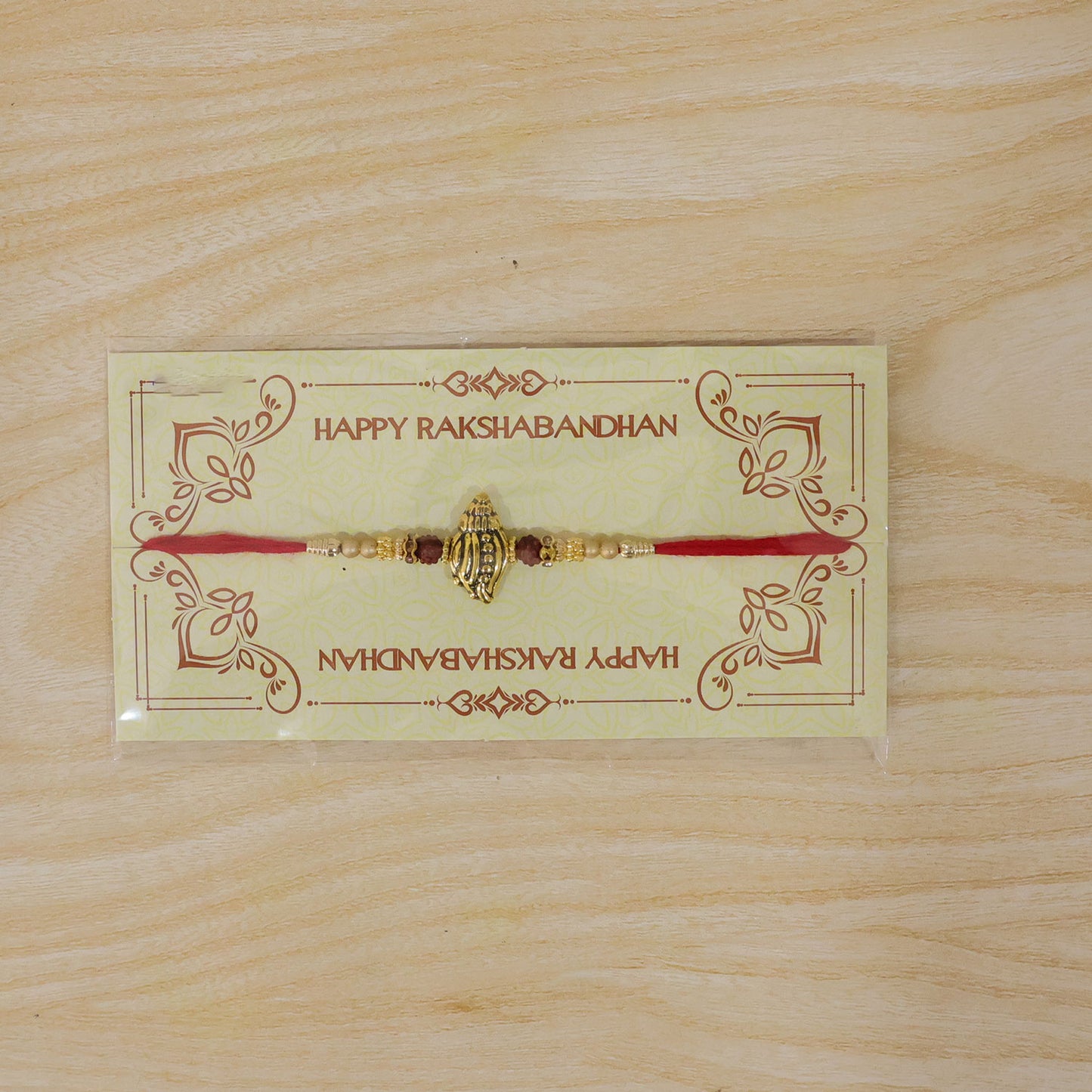 Shankh Conch Golden Devotional Rakhi with Pearl Beads, Red Accents and Antique Finish