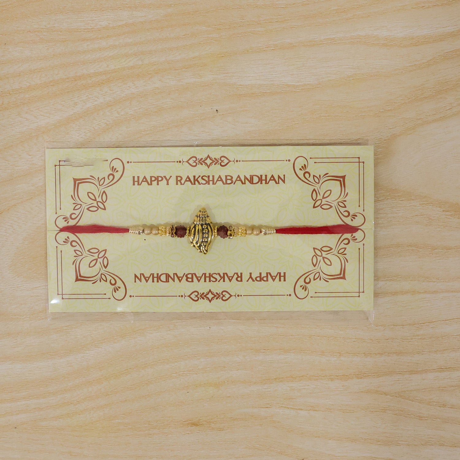 Shankh Conch Golden Devotional Rakhi with Pearl Beads, Red Accents and Antique Finish