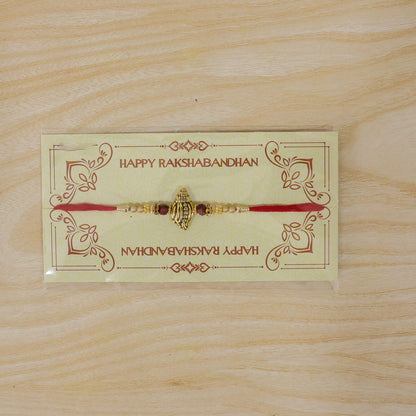Shankh Conch Golden Devotional Rakhi with Pearl Beads, Red Accents and Antique Finish