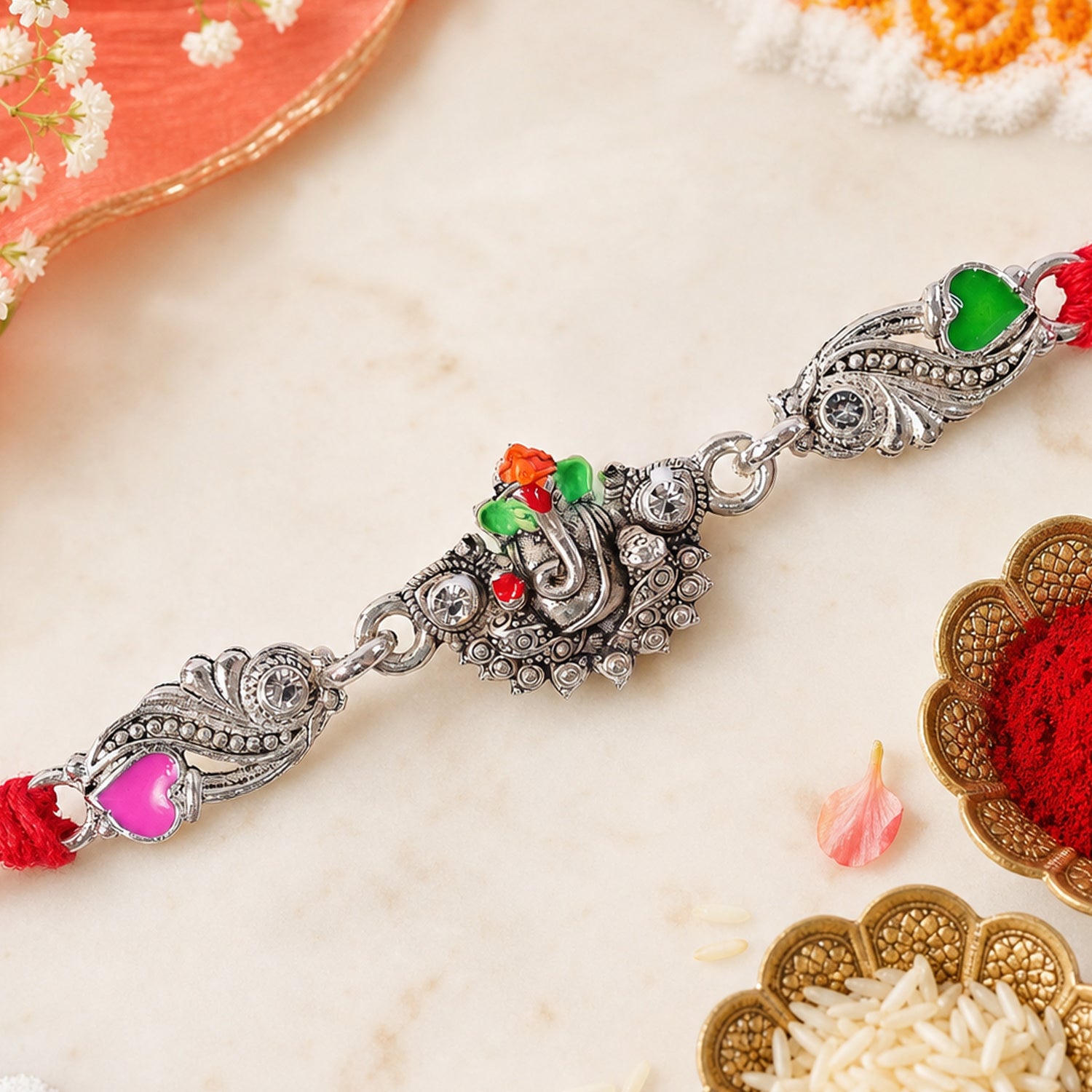 Silver-Toned Lord Ganesha Rakhi with Floral Design, Crystal Accents & Designer Red Thread