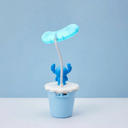 The back of the blue Stitch desk lamp, showing the USB charging port on the light blue base.