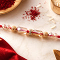 Red Thread Rakhi with Champagne Crystal Beads and Golden Accents