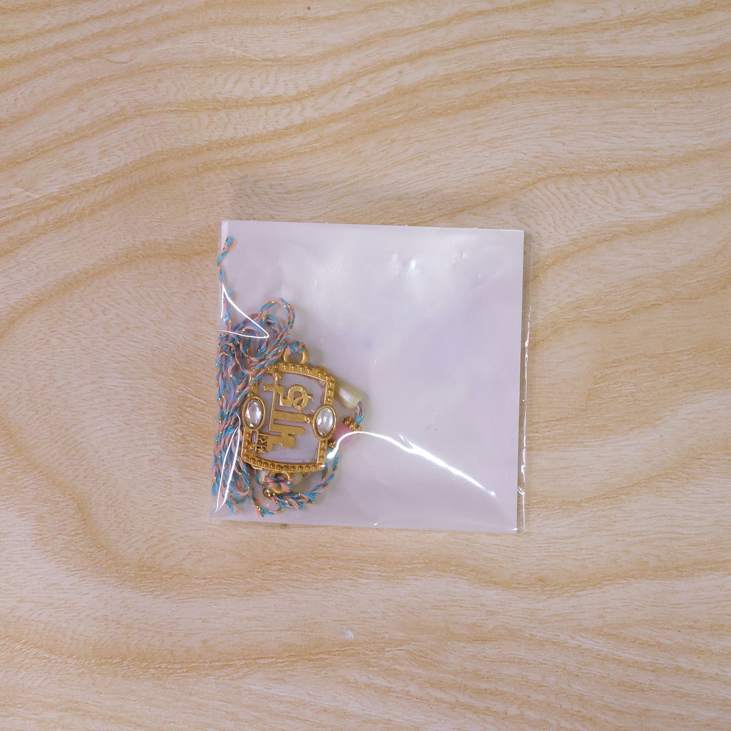 Bhai Script Pendant Rakhi with Lilac Stone and Kundan Accents