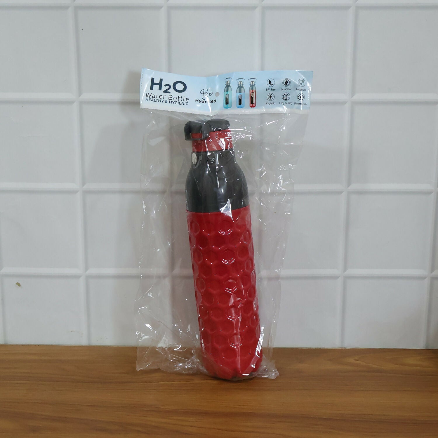 NG insulated water bottle with flip cap closed on outdoor surface