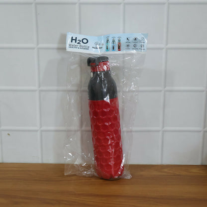 NG insulated water bottle with flip cap closed on outdoor surface